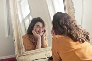 happy woman looking in a mirror