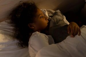 little girl hugging a stuffed animal