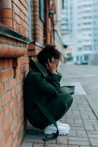 woman crouched down in street