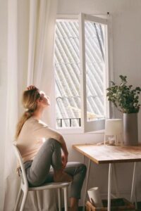 woman sitting by window