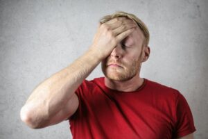 man with hand on his face