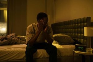 man sitting on bed who can't sleep