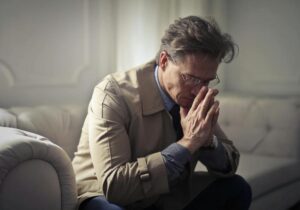 man on couch in thought