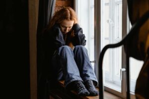 woman sad in a windowseat