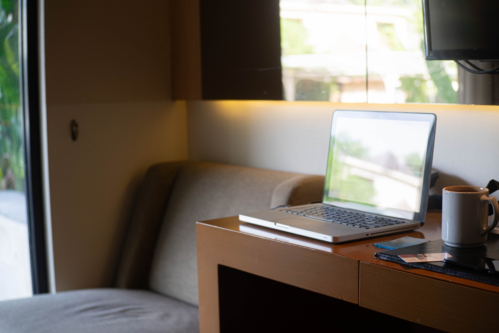 Laptop on table next to sofa